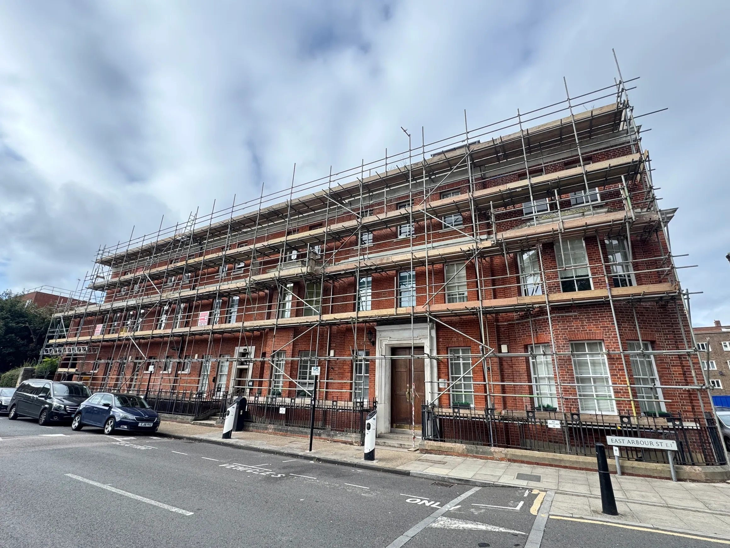 Victorian red brick building under external refurbishment, London